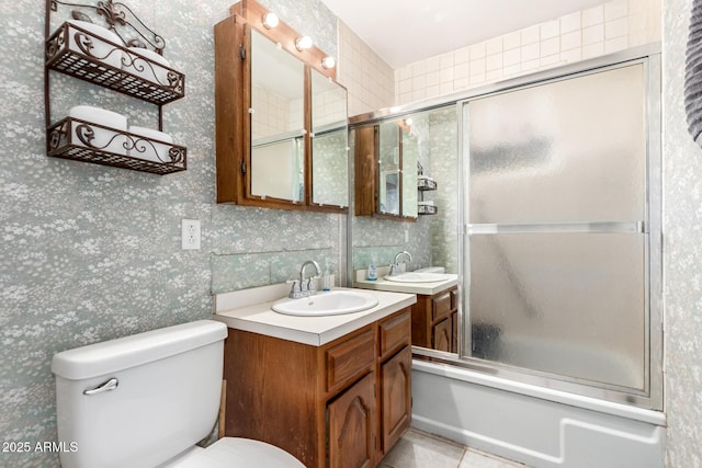 full bathroom with toilet, vanity, and bath / shower combo with glass door