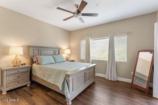 bedroom with ceiling fan and dark hardwood / wood-style flooring