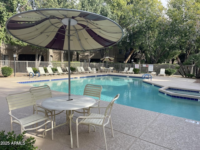 view of pool with a patio and a community hot tub