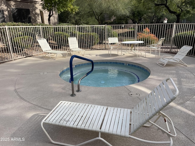 view of swimming pool featuring a community hot tub and a patio area