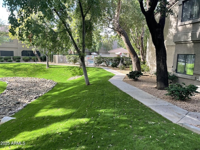 view of property's community featuring a yard