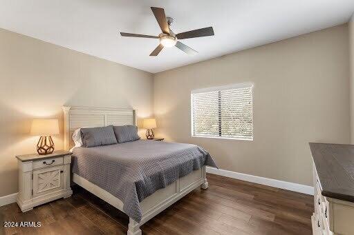 bedroom with ceiling fan and dark hardwood / wood-style flooring