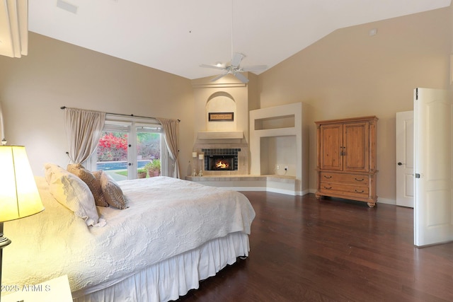 bedroom with lofted ceiling, dark wood-type flooring, access to outside, ceiling fan, and a fireplace