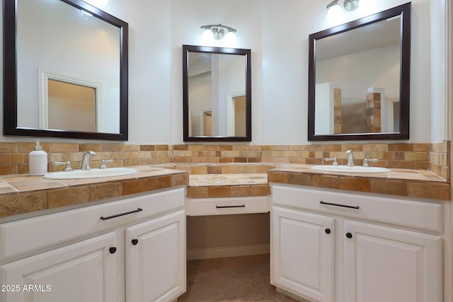 bathroom with tasteful backsplash, tile patterned floors, and vanity