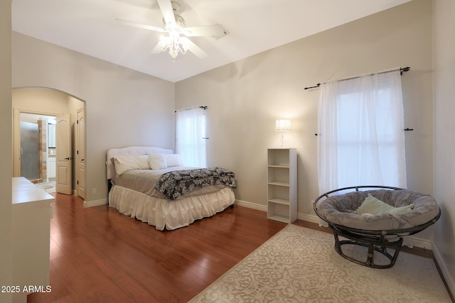 bedroom featuring hardwood / wood-style floors, ceiling fan, and connected bathroom