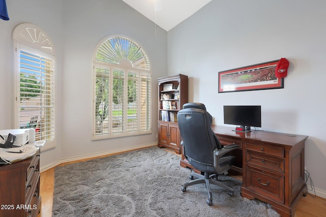 office featuring light wood-type flooring and lofted ceiling