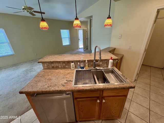 kitchen with vaulted ceiling, sink, hanging light fixtures, light colored carpet, and ceiling fan