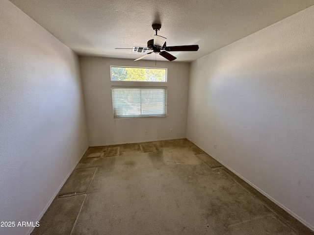 unfurnished room featuring light carpet, ceiling fan, and a textured ceiling