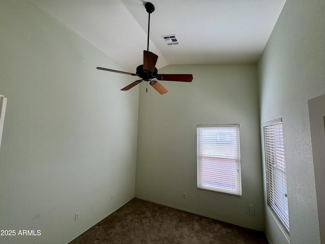 unfurnished room with vaulted ceiling, ceiling fan, and dark carpet