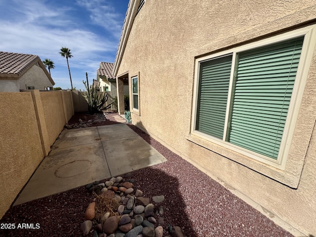 view of property exterior with a patio area