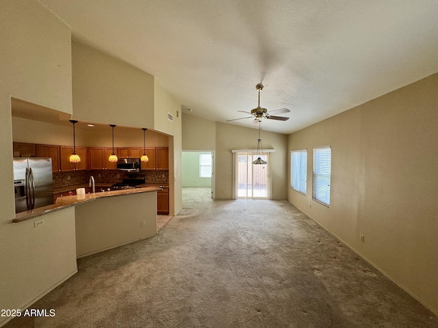 unfurnished living room featuring high vaulted ceiling, light colored carpet, a textured ceiling, and ceiling fan