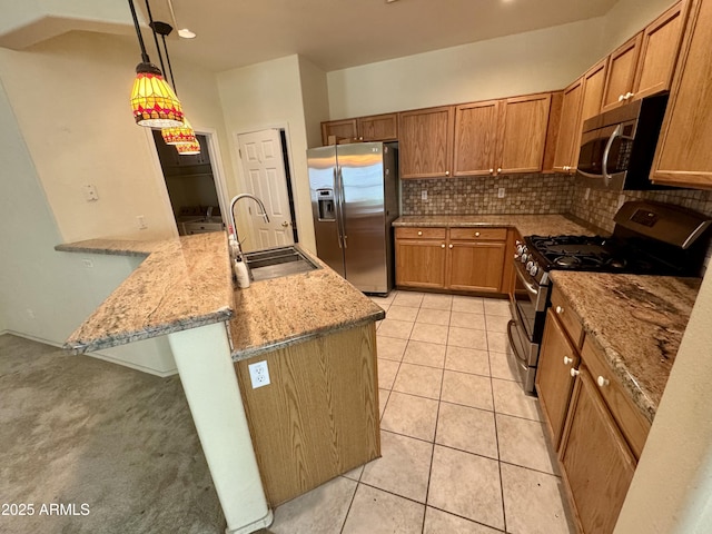 kitchen featuring sink, tasteful backsplash, light stone counters, pendant lighting, and stainless steel appliances