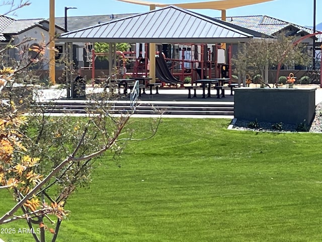 surrounding community with a yard and playground community