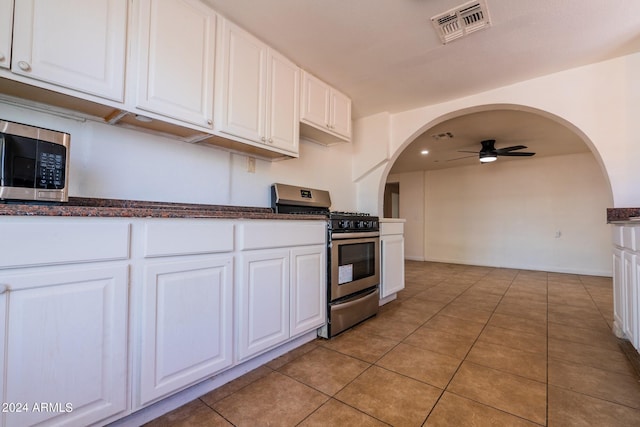 kitchen featuring white cabinets, appliances with stainless steel finishes, light tile patterned floors, and ceiling fan