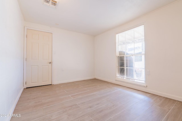 unfurnished room featuring plenty of natural light