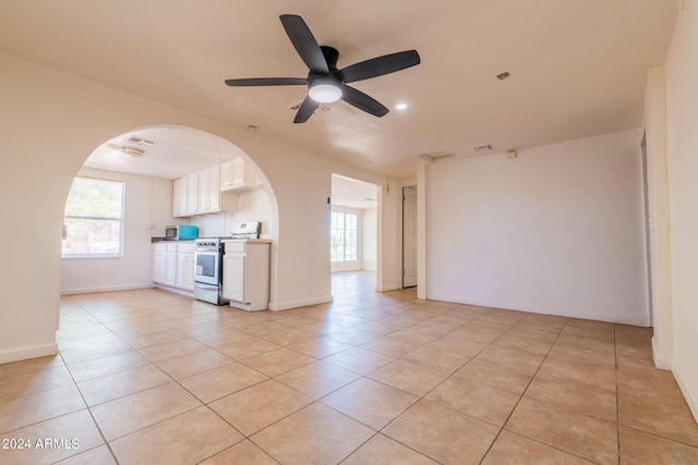 unfurnished living room featuring ceiling fan and light tile patterned flooring