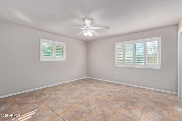 spare room with ceiling fan and a textured ceiling