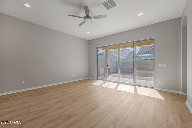 unfurnished room with light wood-type flooring and ceiling fan