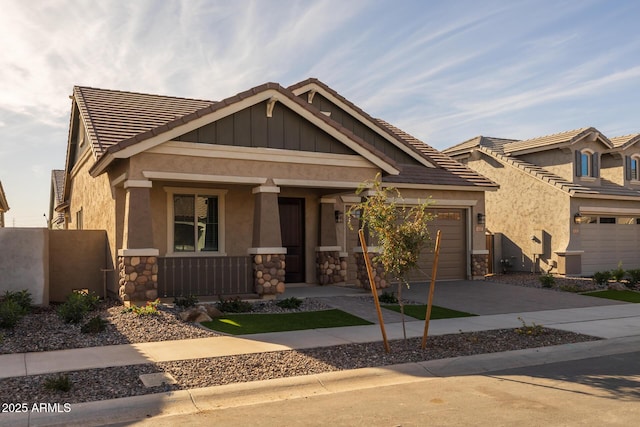 craftsman house featuring covered porch and a garage