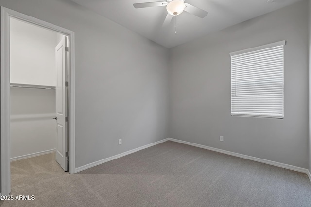 carpeted spare room with ceiling fan