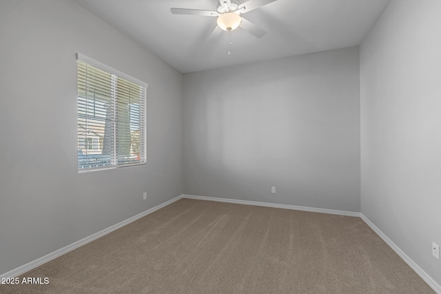 carpeted spare room with ceiling fan