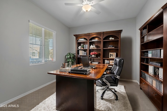 home office featuring carpet floors and ceiling fan