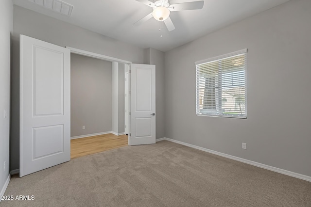 unfurnished bedroom featuring ceiling fan and light carpet