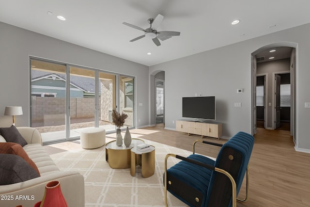 living room featuring hardwood / wood-style floors and ceiling fan