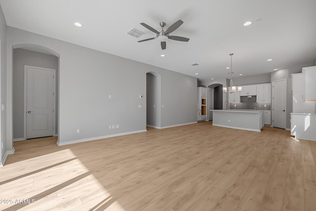 unfurnished living room with ceiling fan and light wood-type flooring