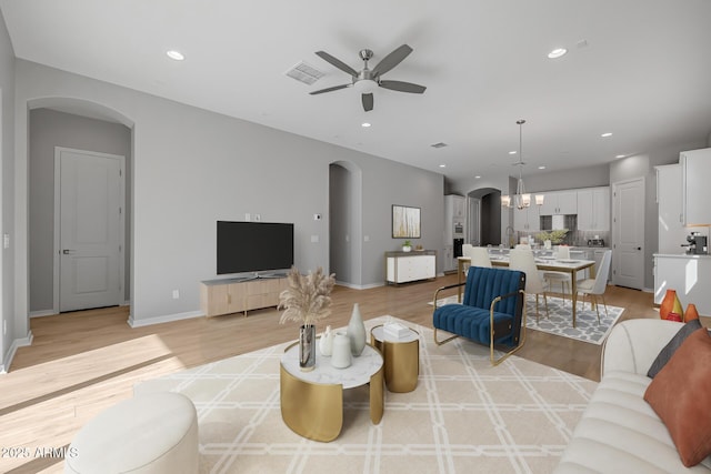 living room featuring ceiling fan and light wood-type flooring