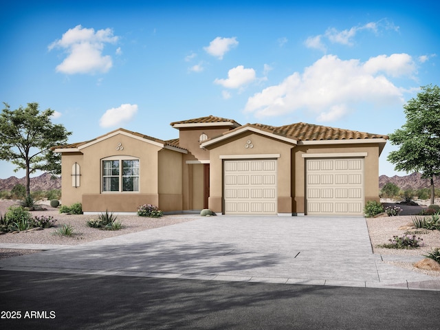 mediterranean / spanish home featuring a tiled roof, stucco siding, an attached garage, and driveway