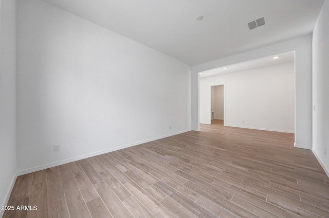 unfurnished room with visible vents, baseboards, and light wood-style floors