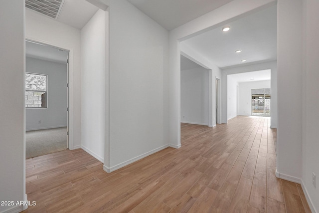 hallway featuring recessed lighting, light wood-type flooring, baseboards, and visible vents