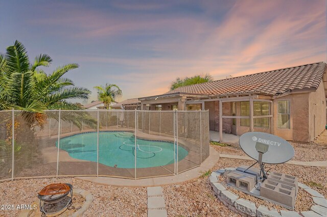 10305 E Dragoon Ave, Mesa, AZ 85208 - pool at dusk featuring an outdoor fire pit and a patio area