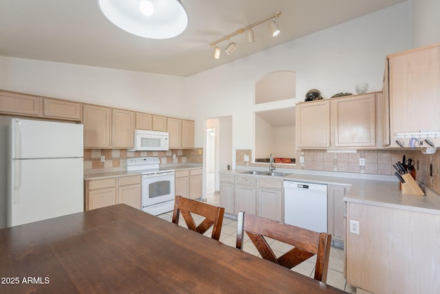 10305 E Dragoon Ave, Mesa, AZ 85208 - kitchen featuring white appliances, decorative backsplash, light tile patterned floors, light brown cabinets, and light countertops