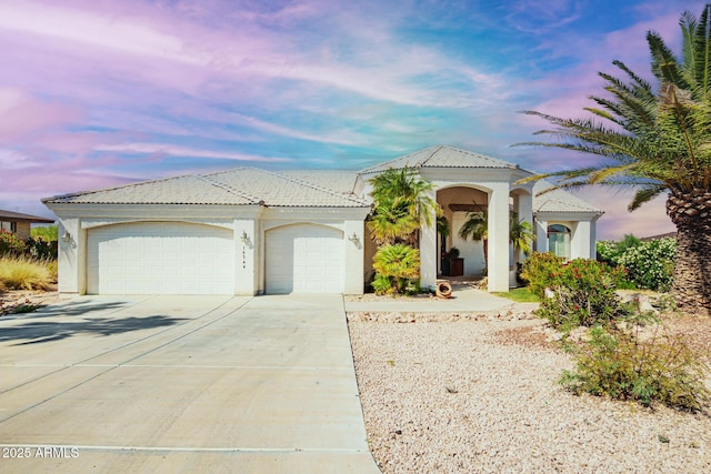 16344 E Bainbridge Ave, Fountain Hills, AZ 85268 - mediterranean / spanish house with a tiled roof, an attached garage, concrete driveway, and stucco siding