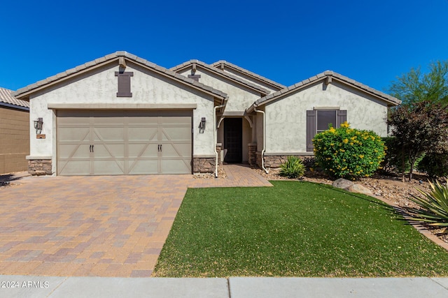 view of front of home featuring a garage and a front lawn