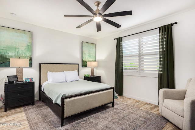 bedroom with ceiling fan and light hardwood / wood-style flooring