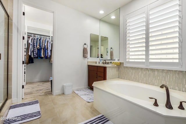 bathroom featuring tile patterned floors, vanity, and independent shower and bath