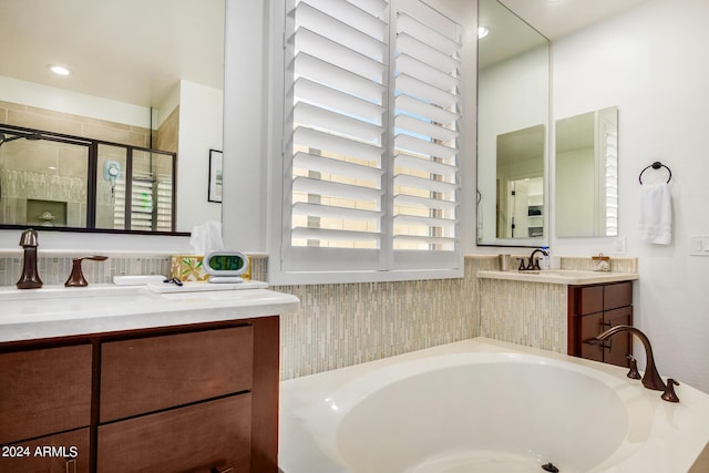 bathroom featuring vanity and independent shower and bath