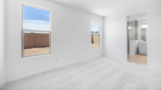25118 N 171st Ln, Surprise, AZ 85387 - unfurnished bedroom featuring carpet, baseboards, and ensuite bath