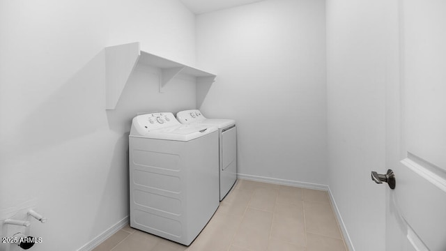 25118 N 171st Ln, Surprise, AZ 85387 - laundry room featuring washer and dryer, baseboards, and light tile patterned flooring