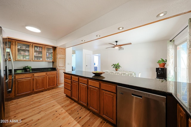 37414 N 17th Ave, Phoenix, AZ 85086 - kitchen featuring stainless steel appliances, brown cabinets, light wood-type flooring, ceiling fan, and glass insert cabinets