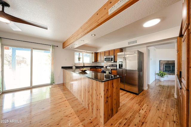 37414 N 17th Ave, Phoenix, AZ 85086 - kitchen with appliances with stainless steel finishes, a peninsula, light wood-style floors, a sink, and brown cabinetry