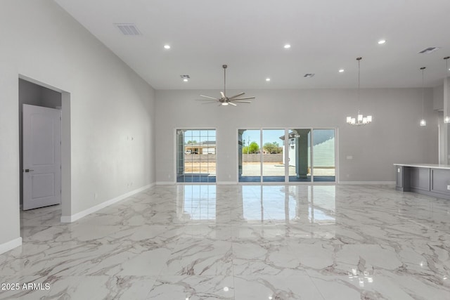 empty room featuring visible vents, marble finish floor, a towering ceiling, and ceiling fan with notable chandelier