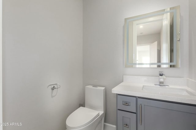 bathroom featuring toilet and vanity