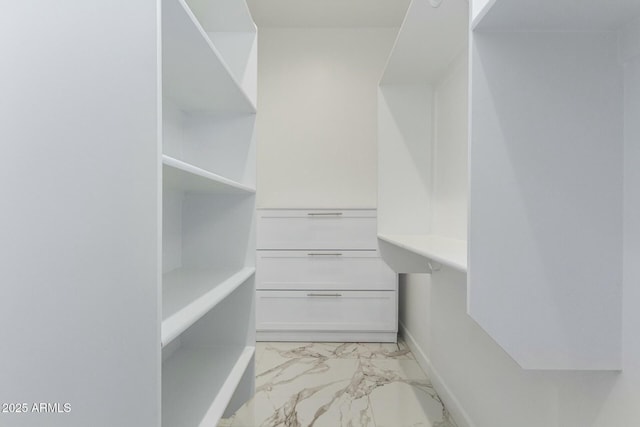 spacious closet featuring marble finish floor