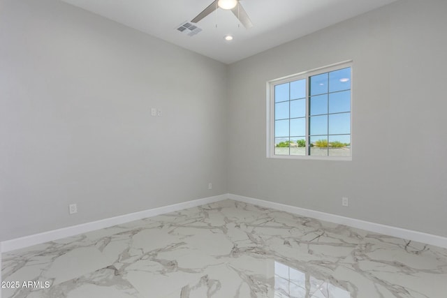 empty room with marble finish floor, baseboards, a ceiling fan, and visible vents