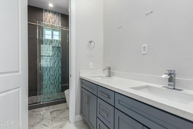 bathroom featuring a sink, toilet, a shower stall, and marble finish floor