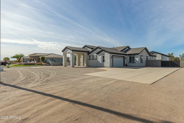 view of front of home featuring an attached garage, fence, stucco siding, and concrete driveway